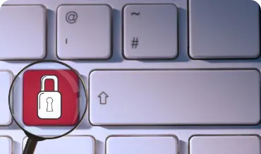 Image of a magnifying glass on a keyboard with a padlock, representing the importance of security in applications.